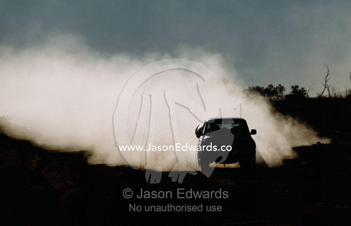 A four-wheel drive vehicle on a dirt road in the outback. Kings Canyon, Watarrka National Park, Northern Territory, Australia.