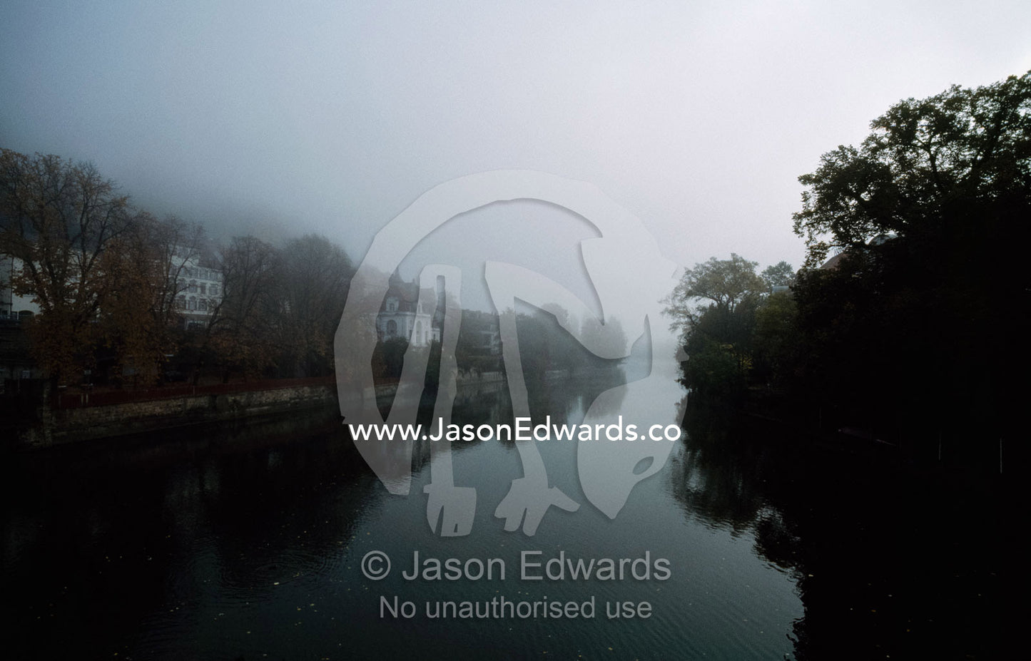 Fog envelops buildings on the Neckar River at Tubingen at dawn. Tubingen, Baden-Wurttemberg, Germany.