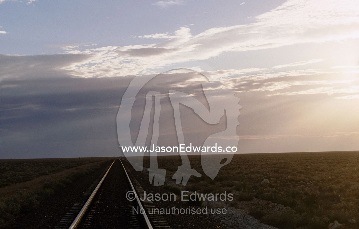 The trans continental railway track rolls across the outback desert. Nullarbor Plain, South Australia.