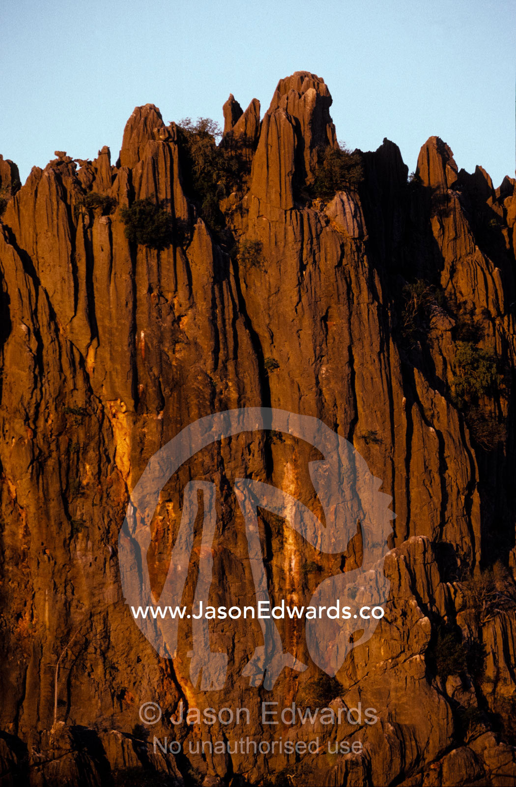Sunset falls over a rugged desert cliff face in Australia's Top End. Windjana Gorge Kimberley Ranges Western Australia.