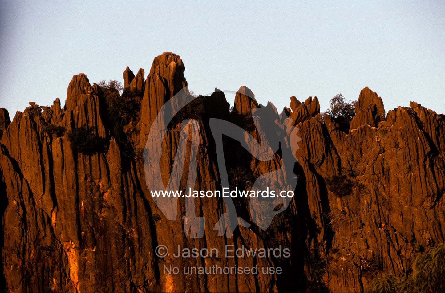 Sunset falls over a rugged desert cliff face in Australia's Top End. Windjana Gorge Kimberley Ranges Western Australia.