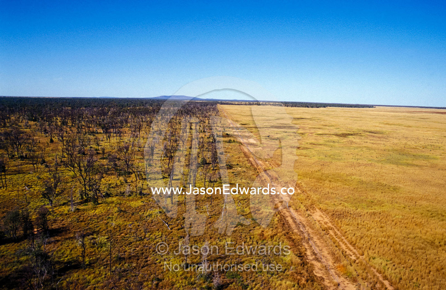 Aerial view of a Dingo fence separating a National Park and farmland. Epping National Park Scientific, Queensland, Australia.
