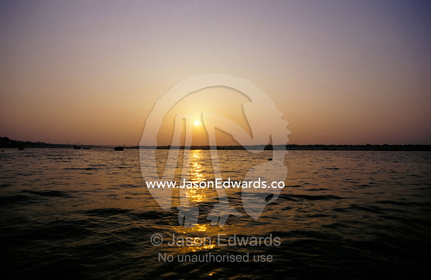 A peaceful scene of the Holy Ganges River aka the Ganga River at dawn. Varanassi, India.