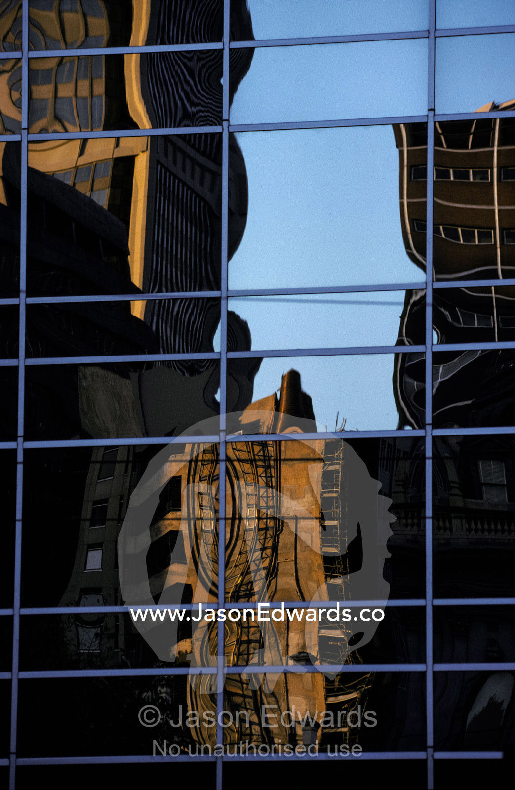 Abstract shapes are reflected in office building windows at days end. Melbourne Victoria Australia.