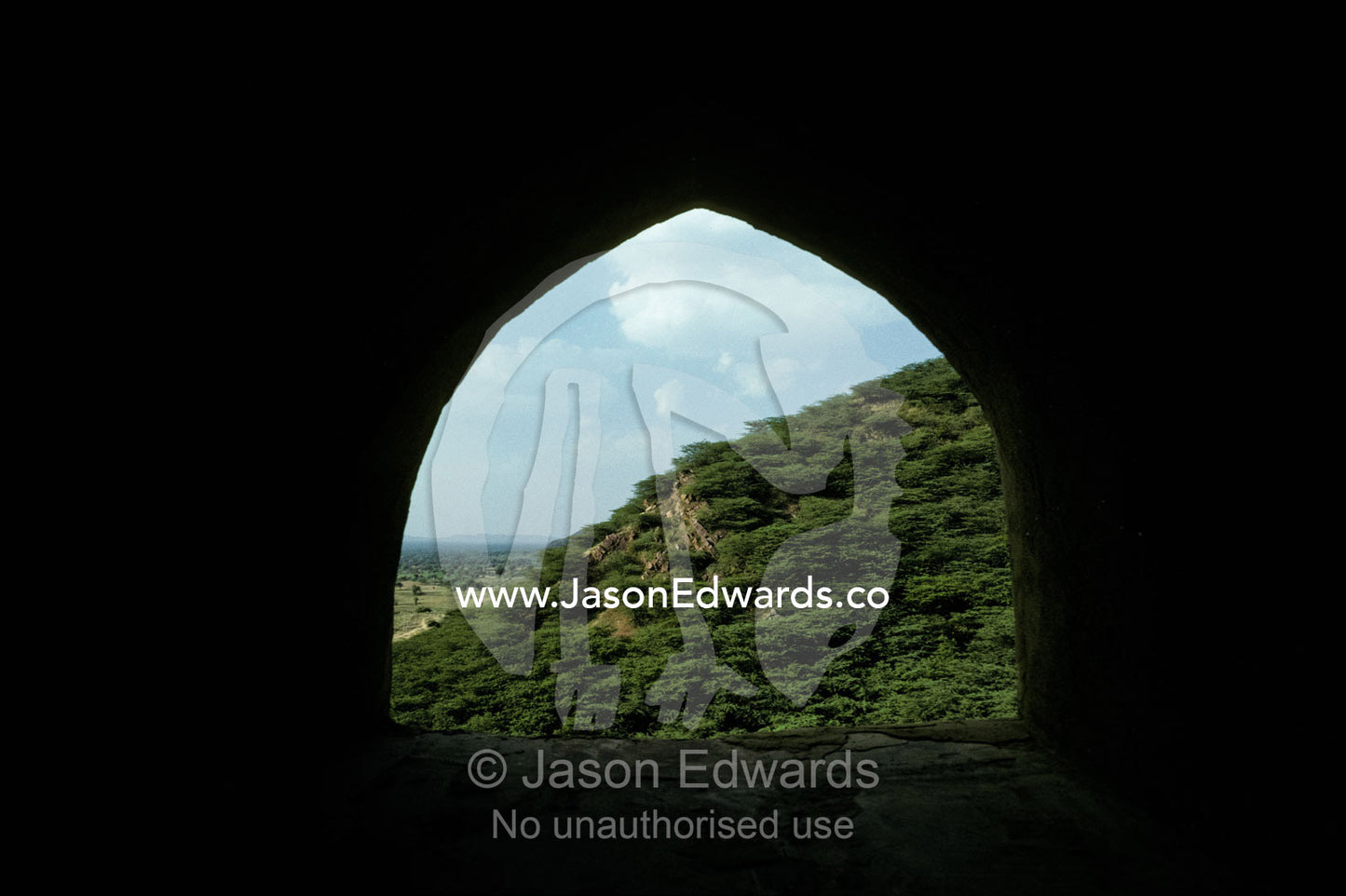 A stone archway looks out from India's Neemrana Fort's battlements. Neemrana Fort Samode India.