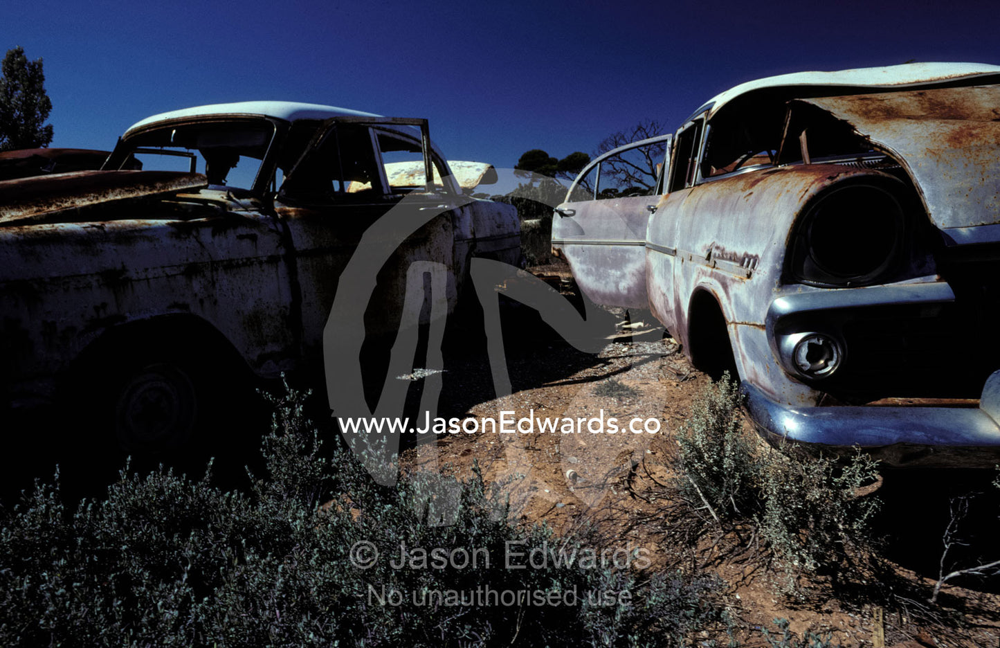 Antique rusting car wrecks in an outback desert junk yard. Konalda Station, Nullabor Plain, South Australia.