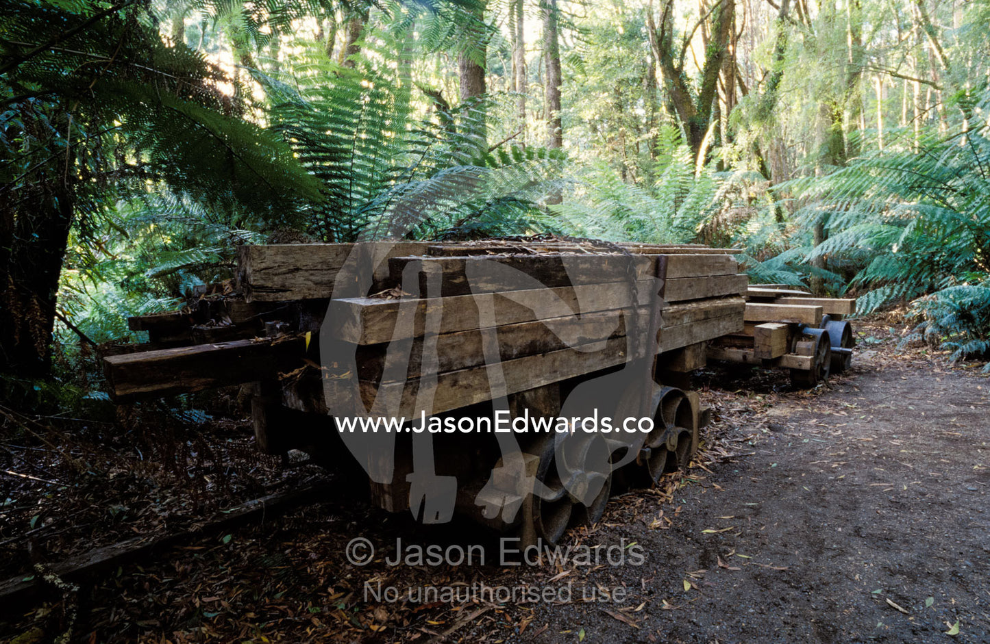 An abandoned antique railway carriage carrying train track sleepers. Cape Otway National Park, Victoria, Australia.
