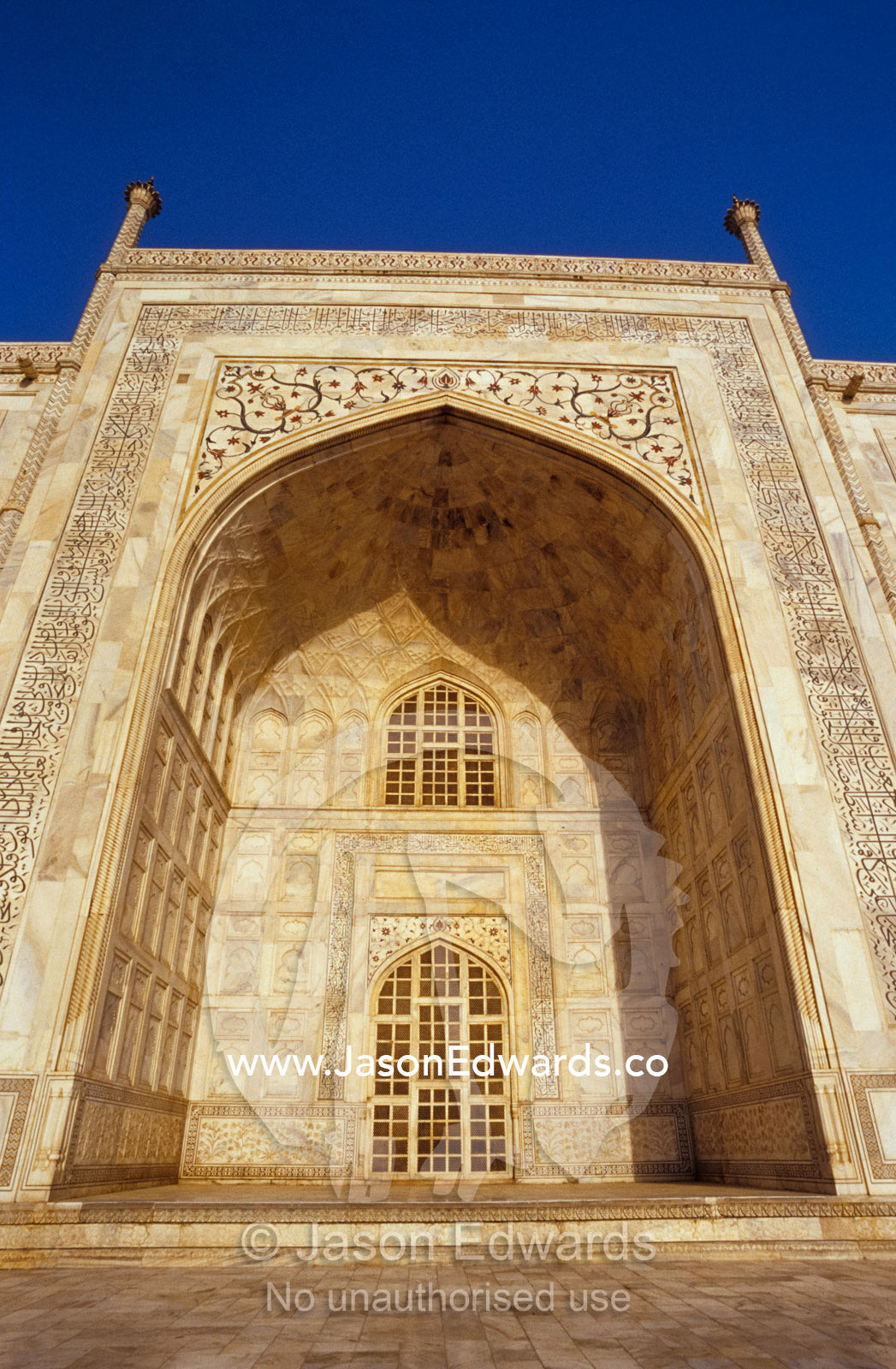 A giant archway of the Taj Mahal with Pietra Dura marble inlay. Agra, India.