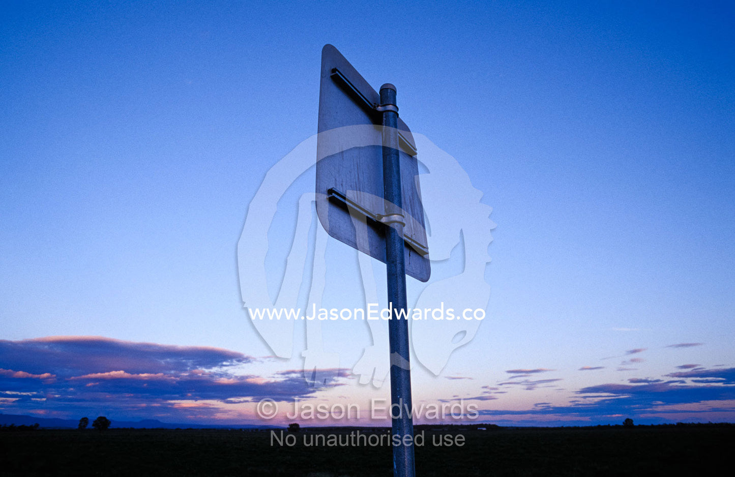 A lonely road sign in the afterglow of sunset on an outback road. Narrabri, New South Wales, Australia.