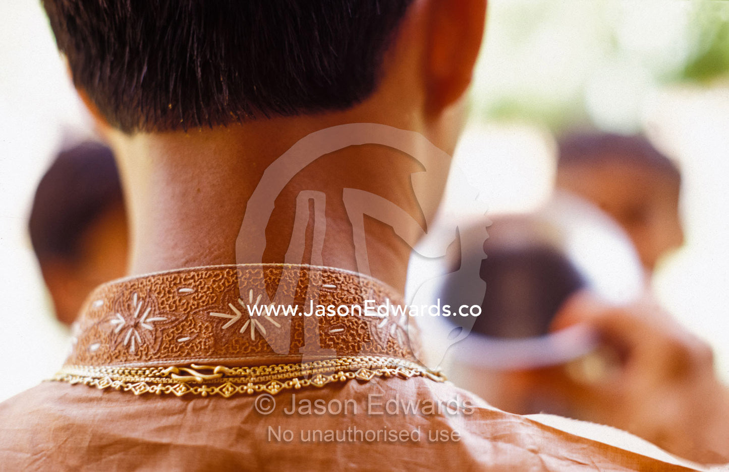 The intricate silk embroidery on the collar of a Hindi groom's robe. Sawai Madhopur, Rajasthan, India.