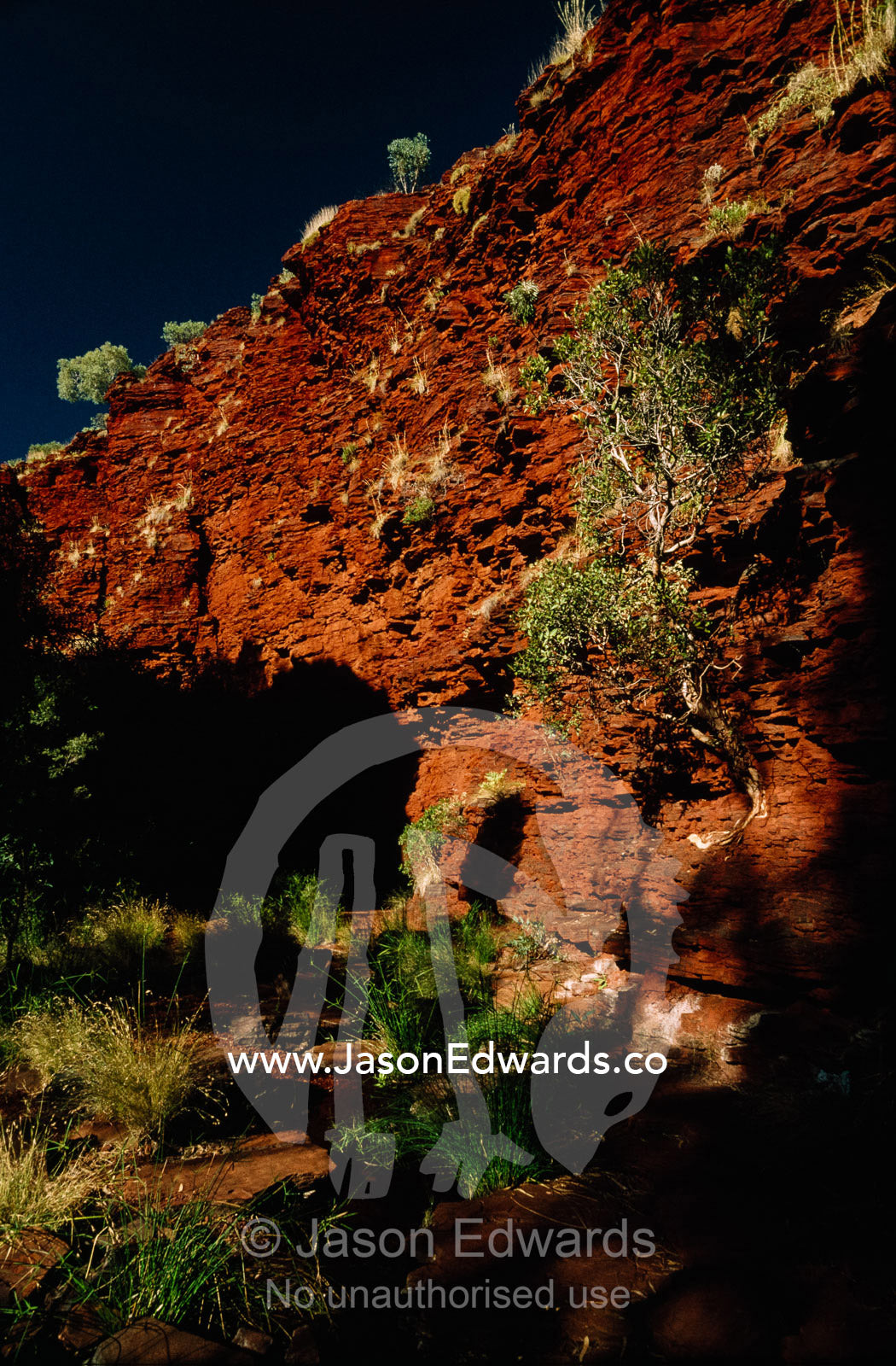 Deep red volcanic walls in a desert gorge. Hamersley Range, Karijini National Park, Western Australia.