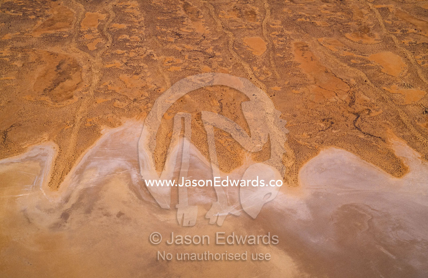Aerial view of salt dunes and shoreline of vast Lake Eyre. Lake Eyre National Park, South Australia.