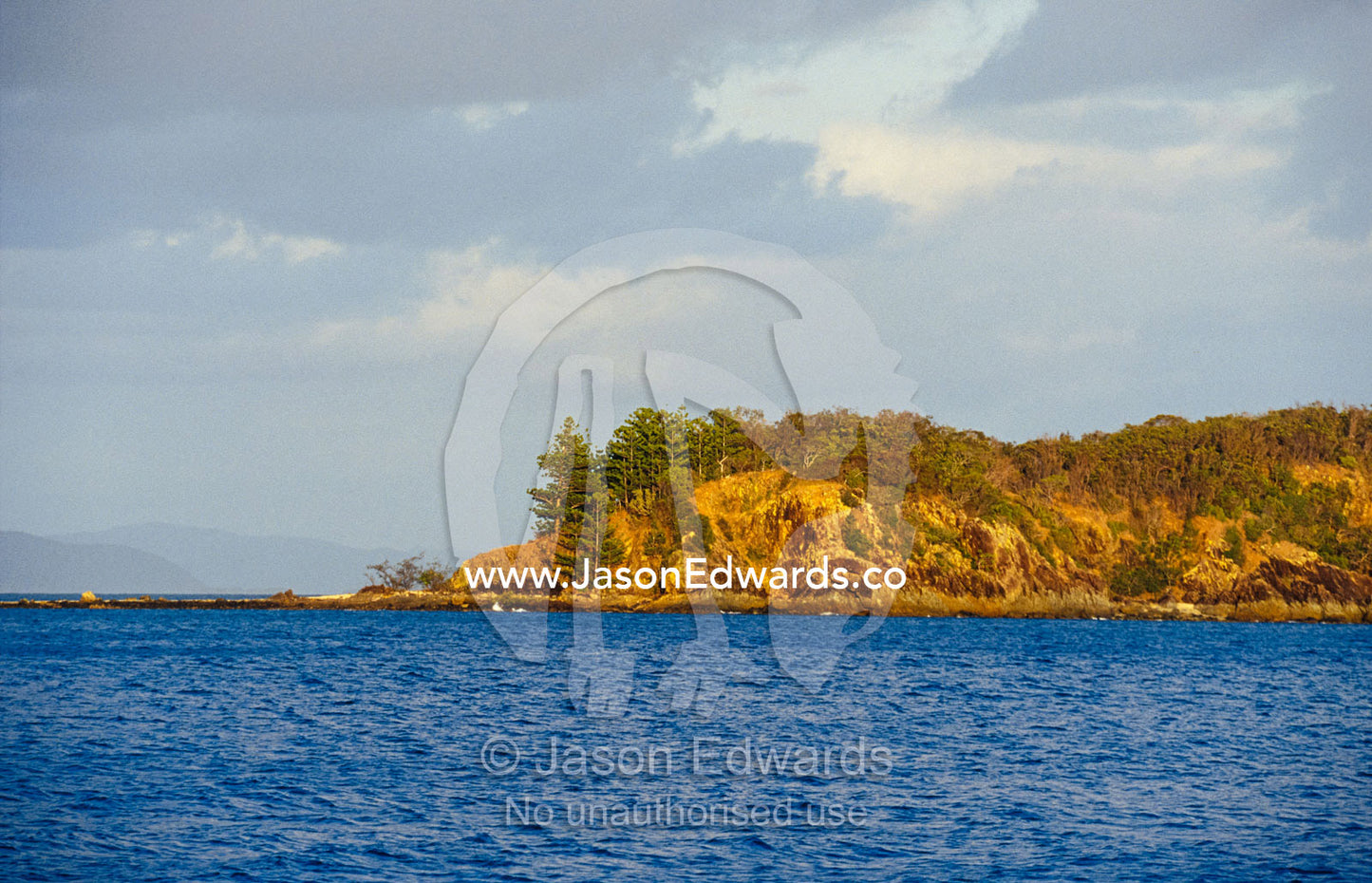 The tip of a tropical island reaches into the Whitsunday passage. Whitsunday Islands, Queensland, Australia.
