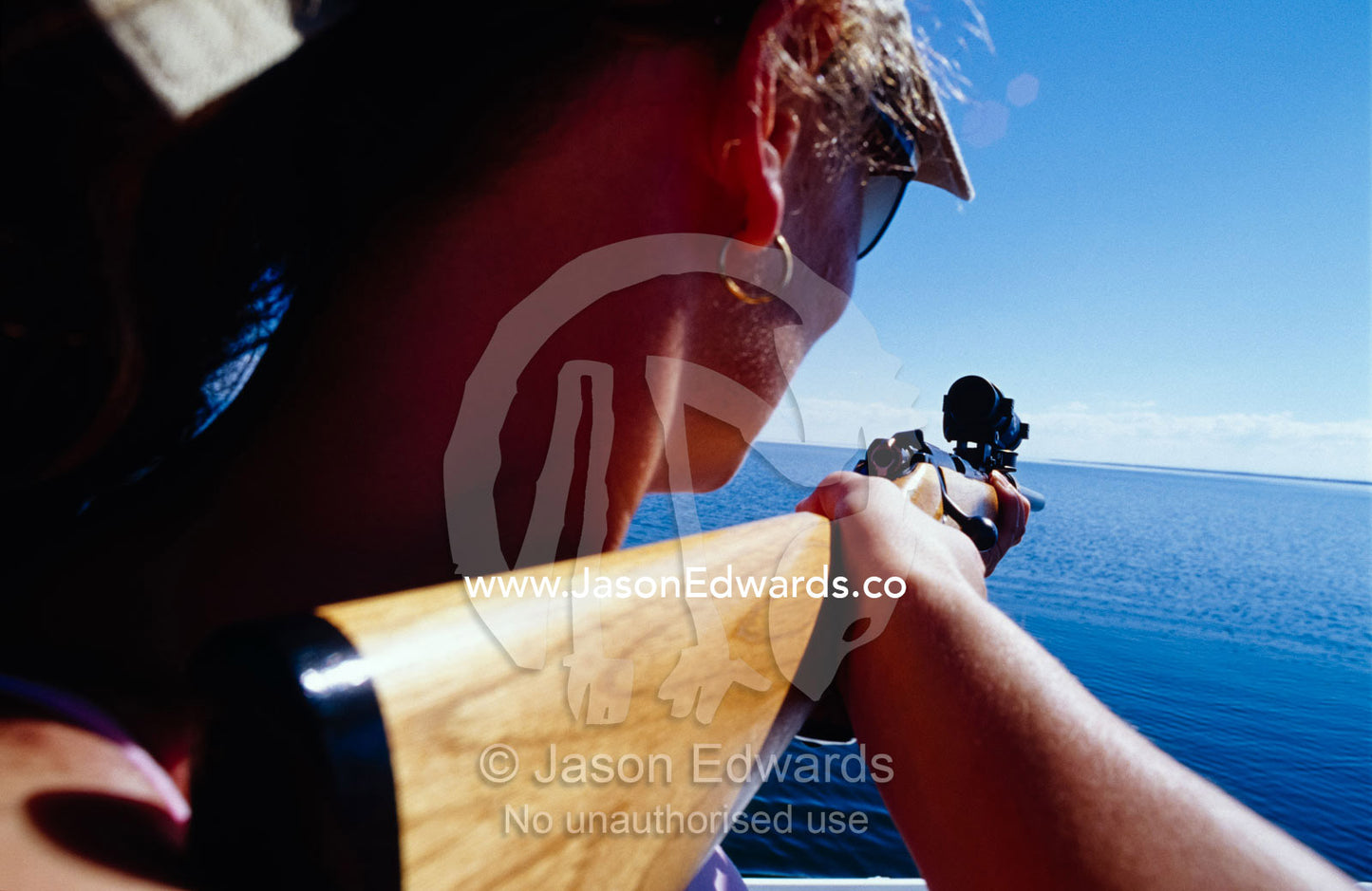 A Phd candidate collecting DNA samples from dolphins using a dart gun. The Lakes National Park, Victoria, Australia.