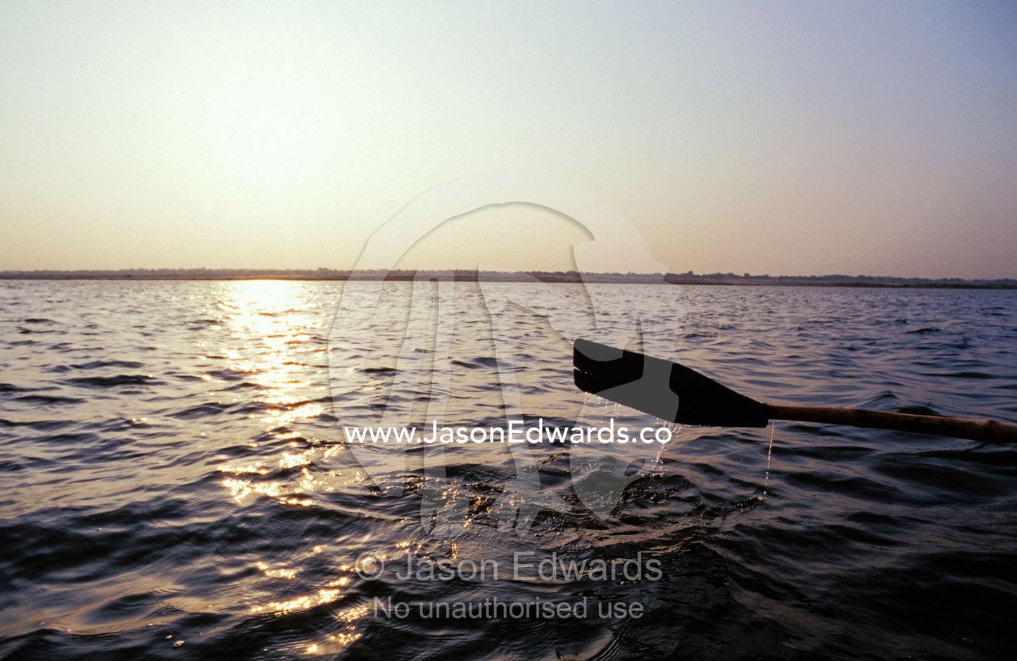 An oar rowing a boat along the holy Ganges River at dawn. Varanasi, Uttar Pradesh, India.