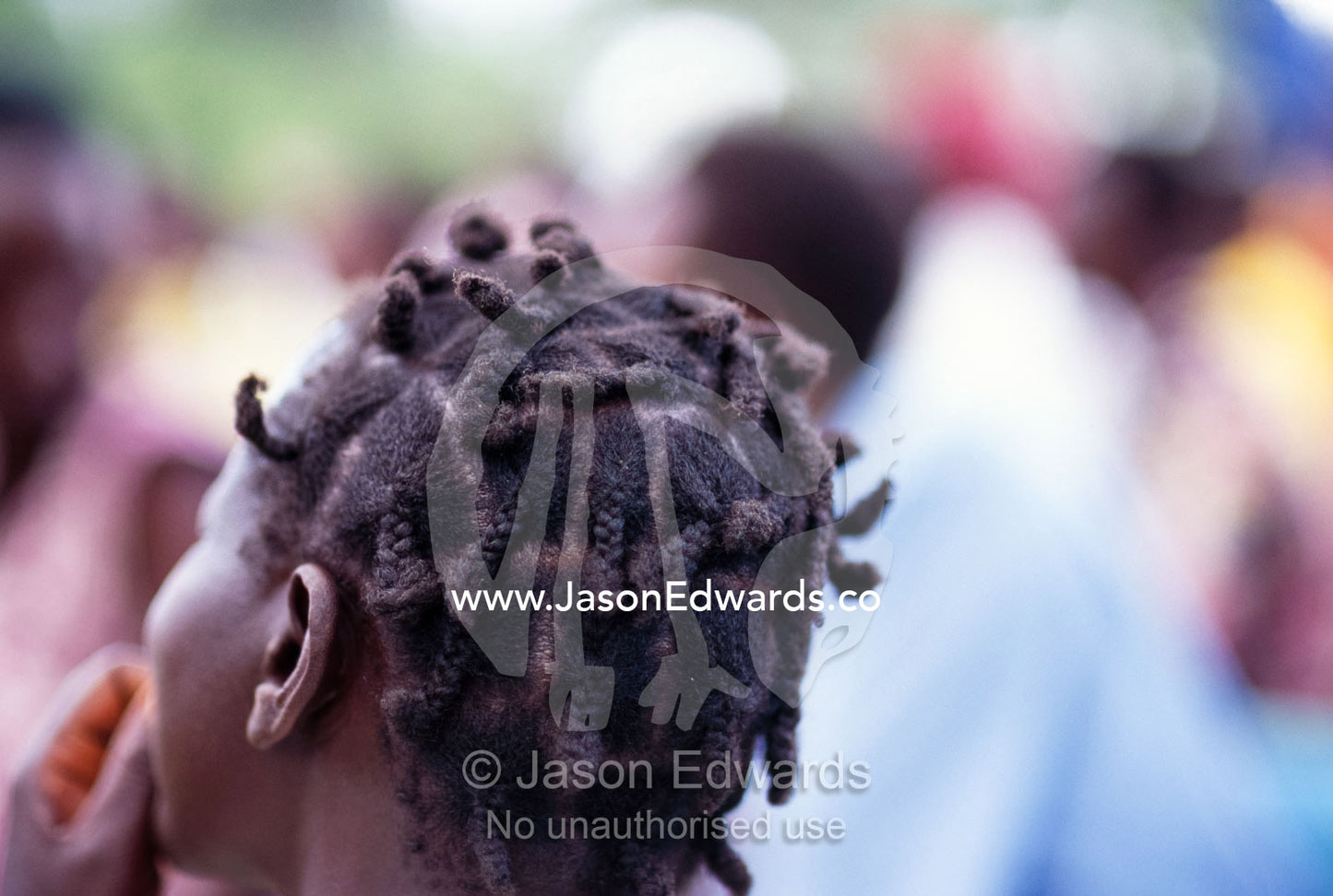 The tightly bound hair of an East African woman at a gathering. Tororo District, Uganda.