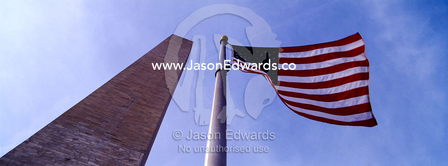 The American flag, Old Glory, flies near the Washington Monument. Washington DC, USA, United States of America.