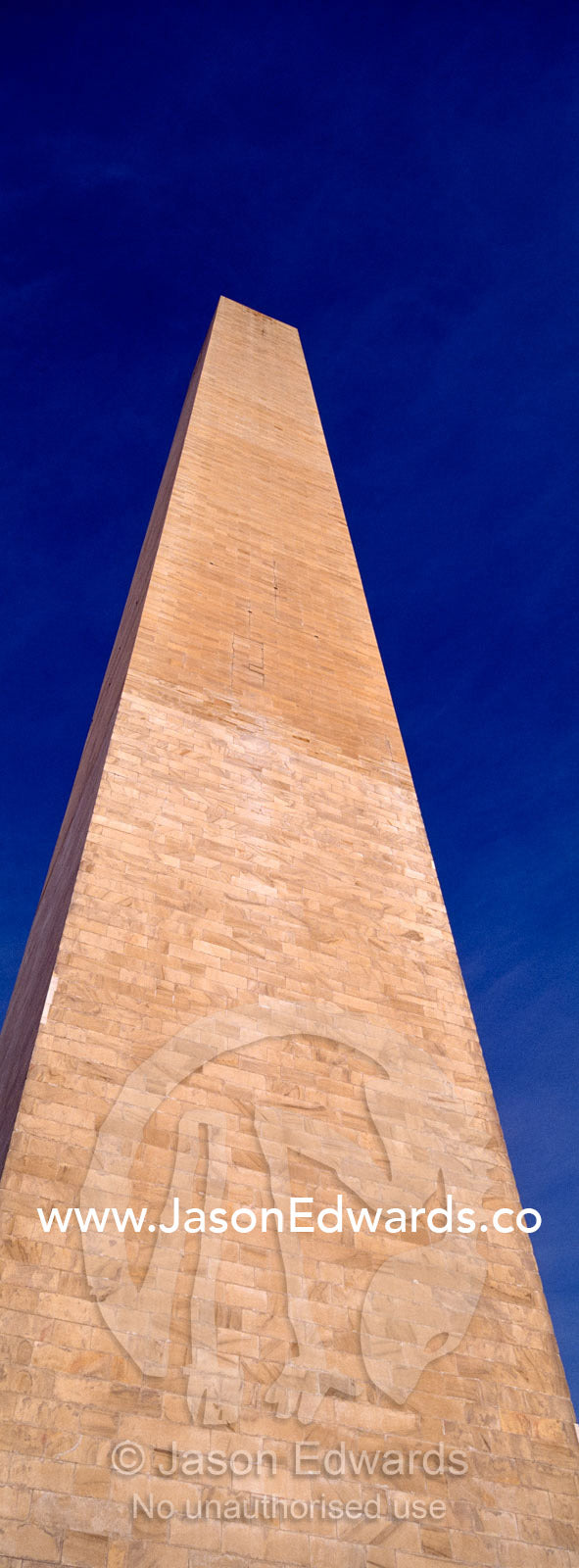 The Washington Monument stands tall in a clear, blue winter sky. Washington DC, USA, United States of America.