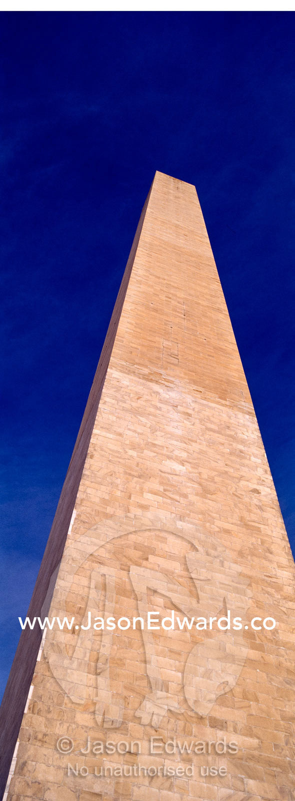 The Washington Monument stands tall in a clear, blue winter sky. Washington DC, USA, United States of America.
