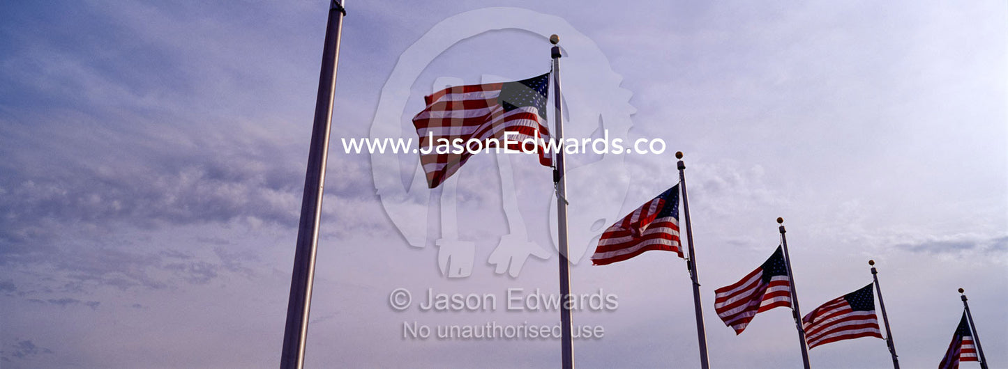 The American flag, Old Glory, flies near the Washington Monument. Washington DC, USA, United States of America.