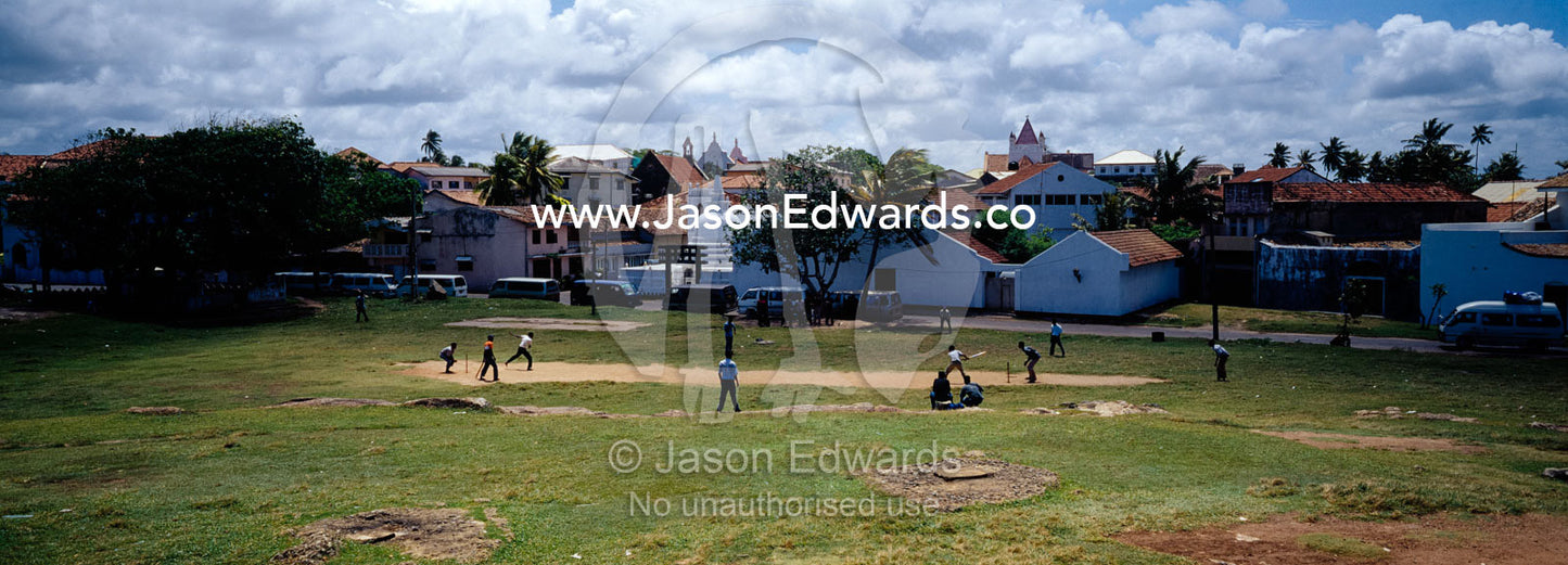 A group of men play a game of cricket the national sport of Sri Lanka. Galle, Sri Lanka.