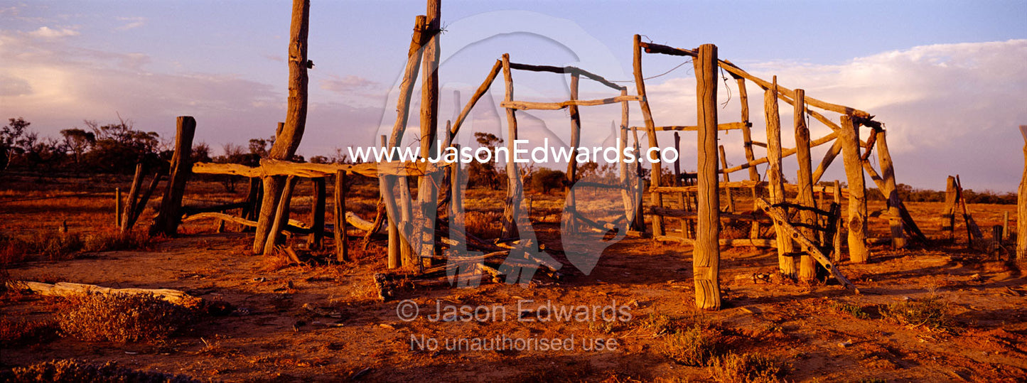 Sunset over antique cattle station homestead ruins in the desert. Sturt National Park, New South Wales, Australia.