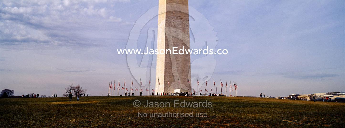 American flags fly proudly at the base of the Washington Monument. Washington DC, USA, United States of America.