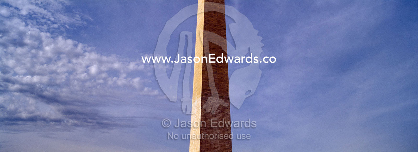 The Washington Monument stands tall in a blue winter sky. Washington DC, USA, United States of America.