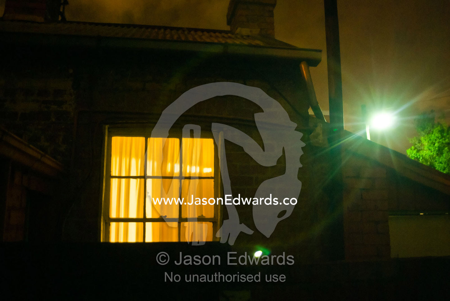 Light shines through the window of a nineteenth century terrace home. North Carlton, Victoria, Australia.