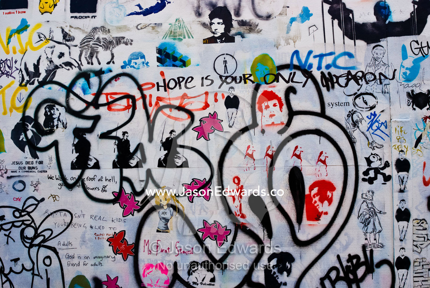 Graffiti artists leave their mark on a building wall in a city lane. Carlton, Victoria, Australia.