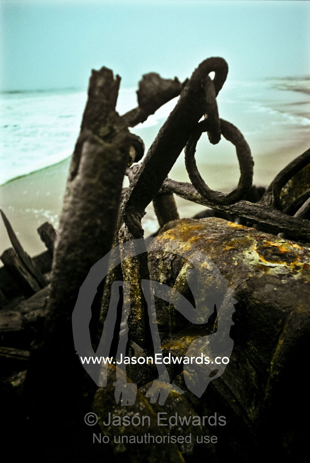 The tortured rusting remains of a shipwreck on a cold desolate beach. Skeleton Coast National Park, Namibia.
