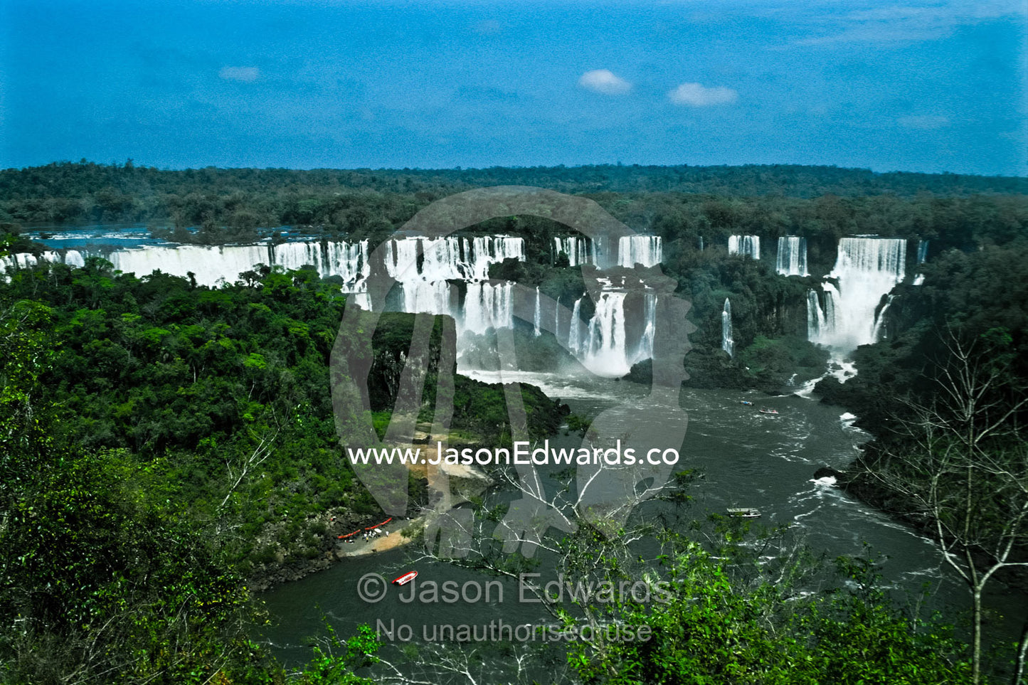 The Iguazo River plummets through steaming subtropical rainforest. Iguazo Falls, Iguazu National Park, Argentina.