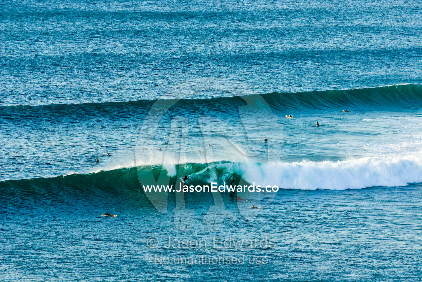 Surfers vie for position in the lineup as surf peels off Rincon Point. Bells Beach Surfing Recreation Reserve, Surf Coast, Victoria, Australia.