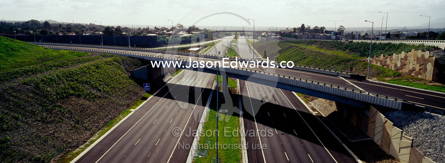 A freeway devoid of vehicles beneath empty overpasses. Eastern and Southeastern Suburbs, Melbourne, Victoria, Australia.