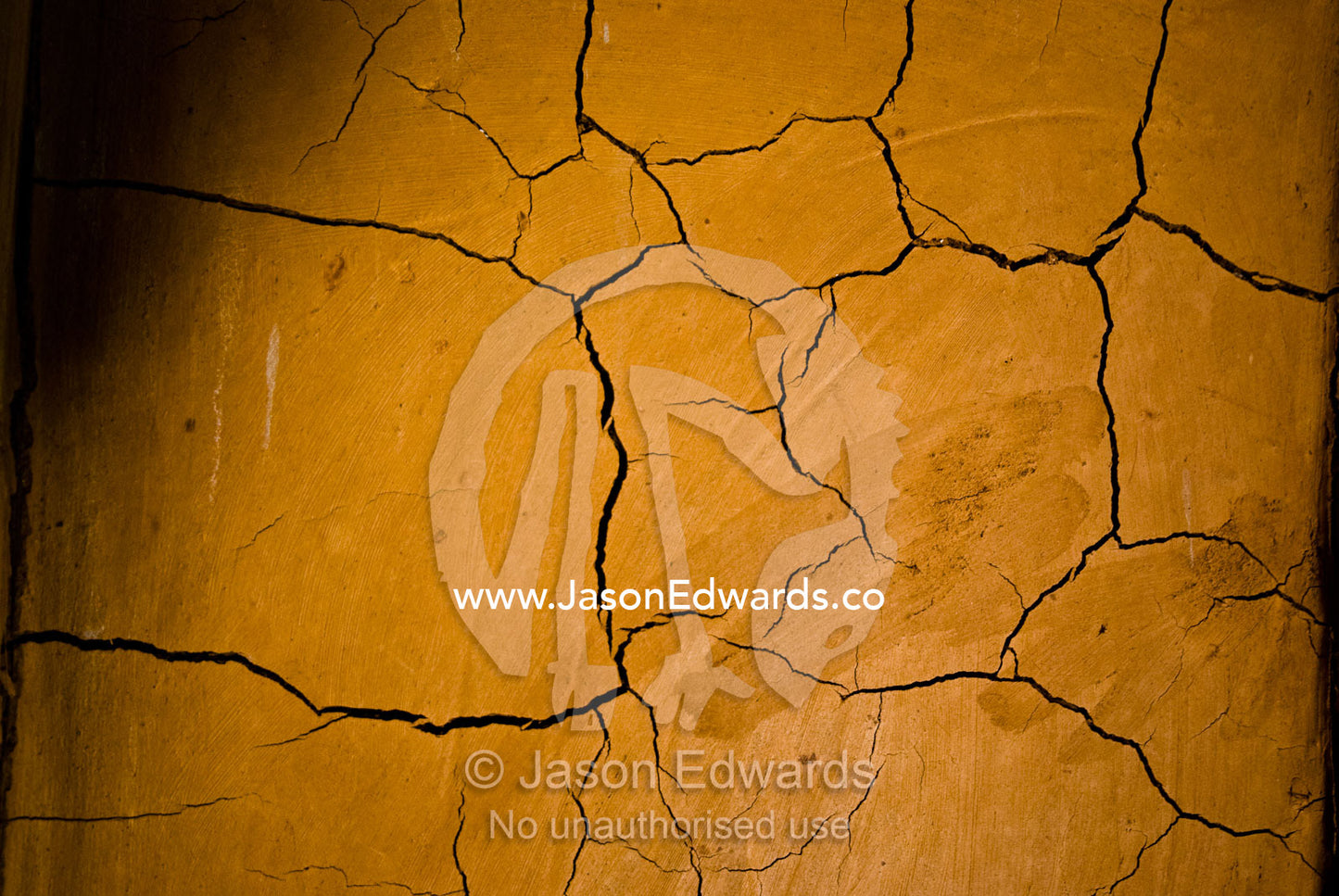 Cracks are a deliberate feature of a volcanic mud wall in a villa. The Temple Lodge, Bukit Peninsula, Bali, Indonesia.