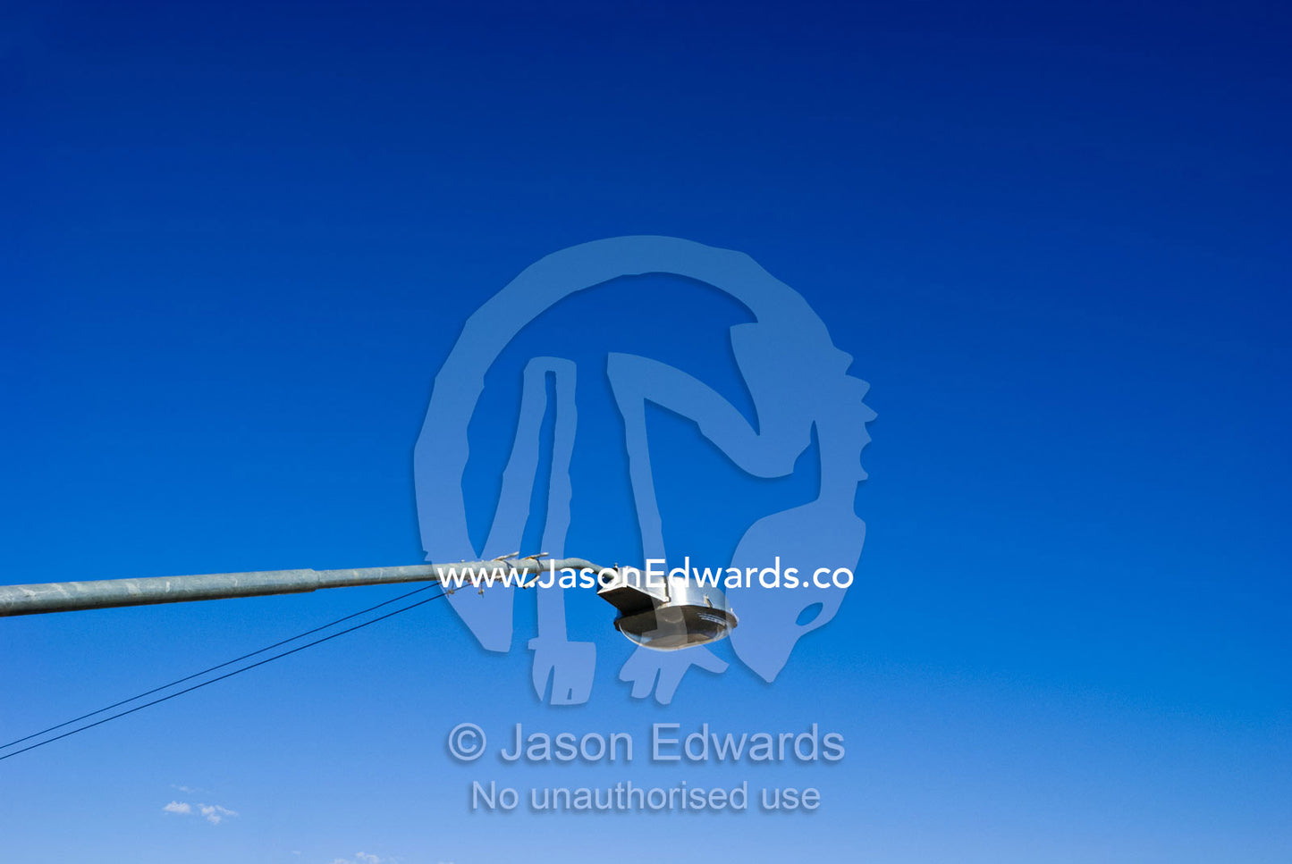 A electric street light reaches into the clear blue desert sky. Broken Hill, New South Wales, Australia