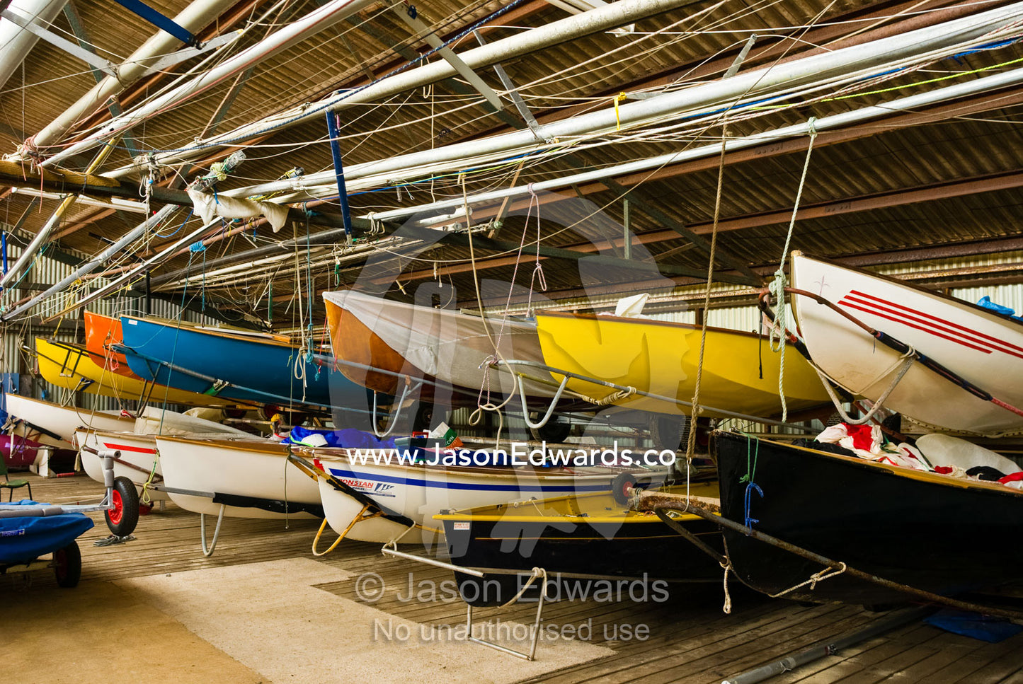 Yachts and rigging clutter a boathouse at a city beach yacht club. Port Melbourne, Victoria, Australia.