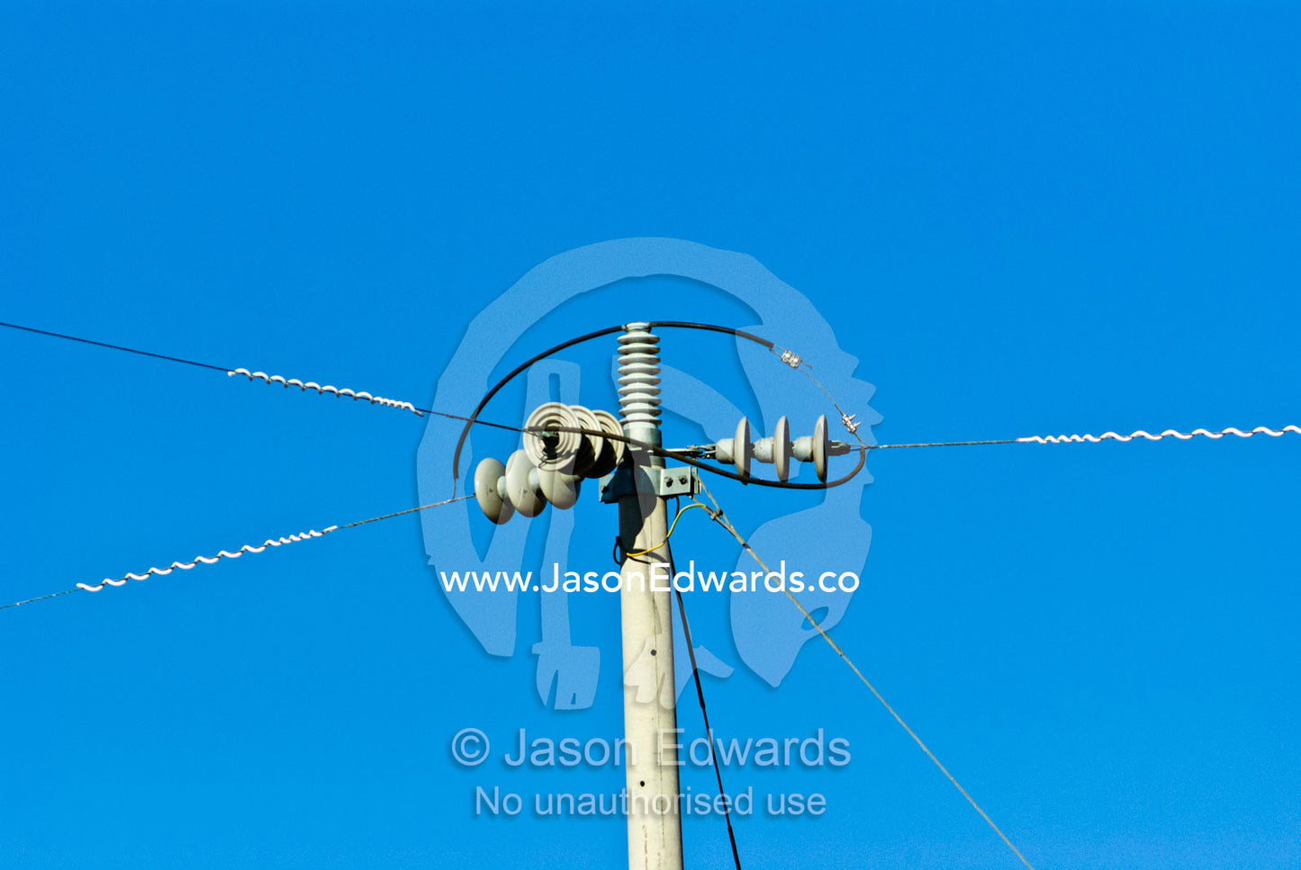 Power cables come together on an electricity pole on a cattle station. Mount Wood Station, New South Wales, Australia.