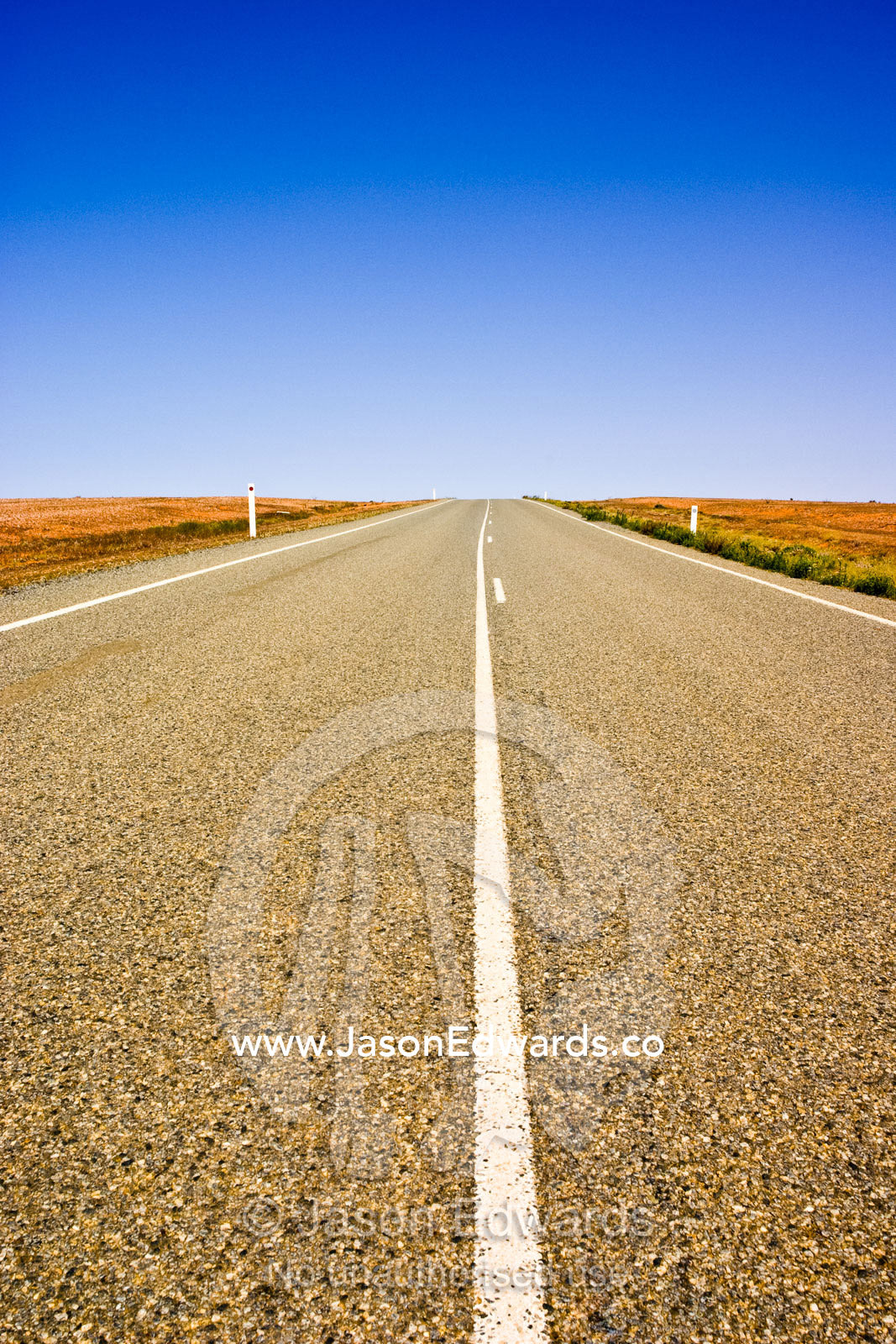 A lonely open stretch of road disappears over the desert horizon. near Stephens Creek, outback western New South Wales, Australia.