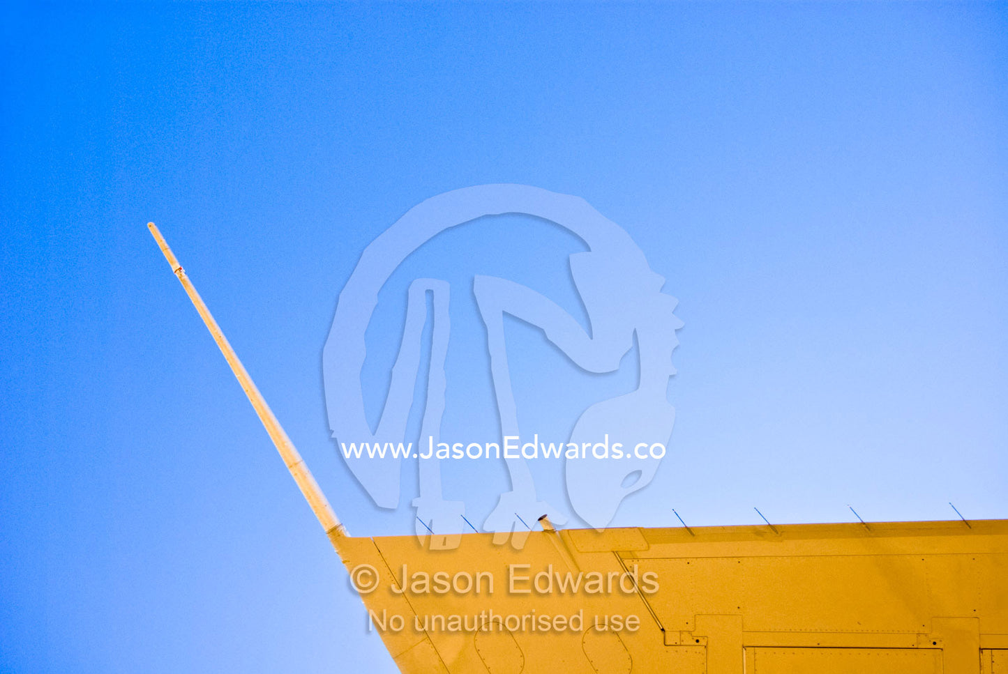 The wing tip of a 747 passenger aircraft soars into a clear blue sky. Longreach, Queensland, Australia