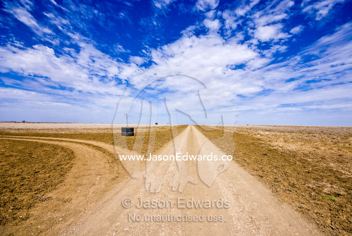A rough dirt track constitutes a major arterial road in the Outback. Hughenden Muttaburra Road, Queensland, Australia