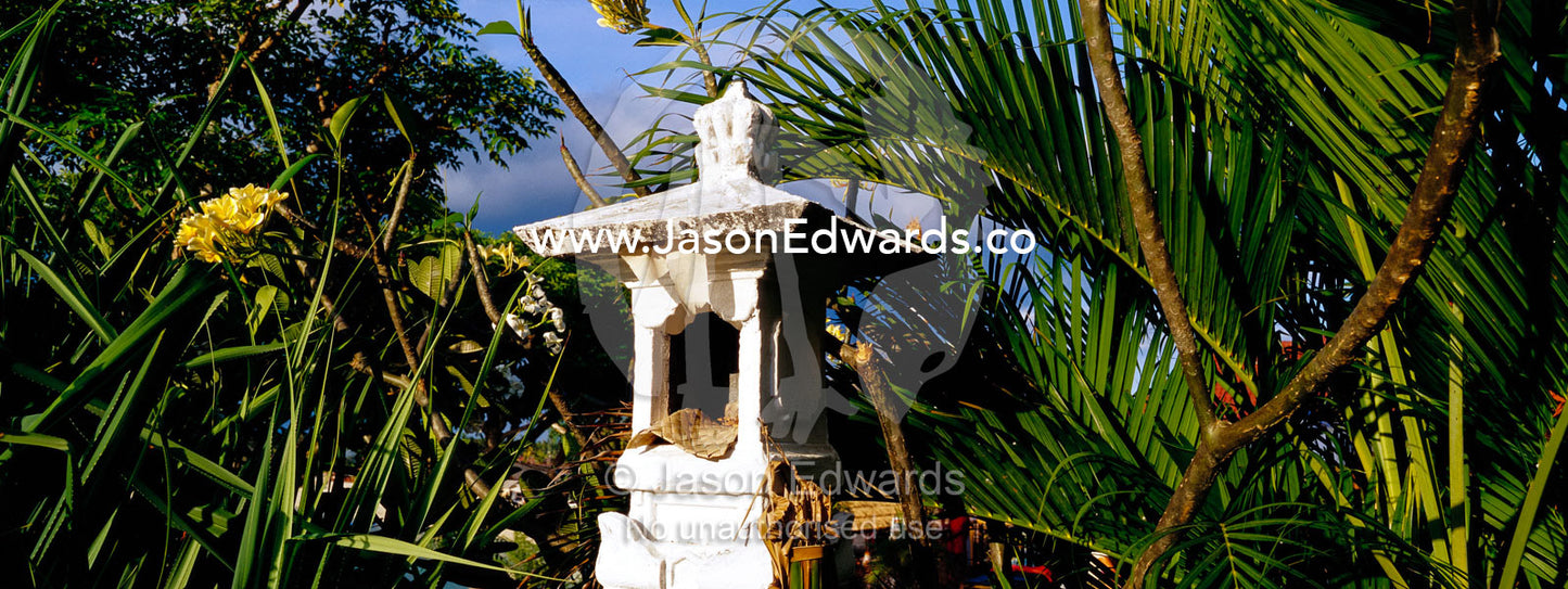A small Hindu Temple surrounded by palm fronds on an island hilltop. Nusa Lembongan Island, Bali, Indonesia