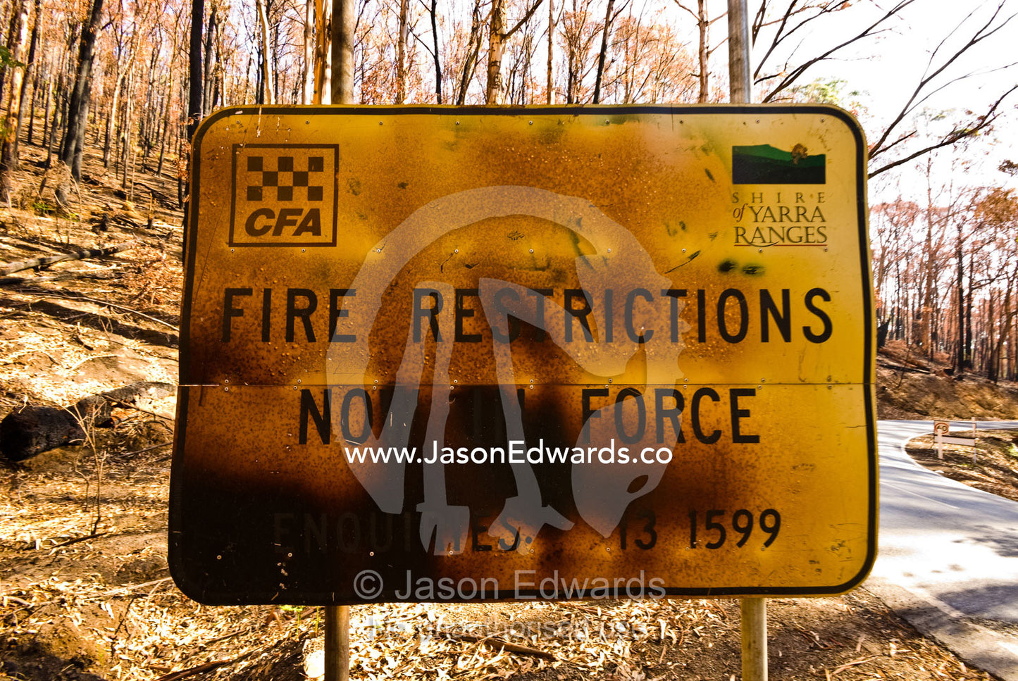 An official fire restriction sign in a national park destroyed by fire Near Toolangi, Yarra Ranges National Park, Victoria, Australia