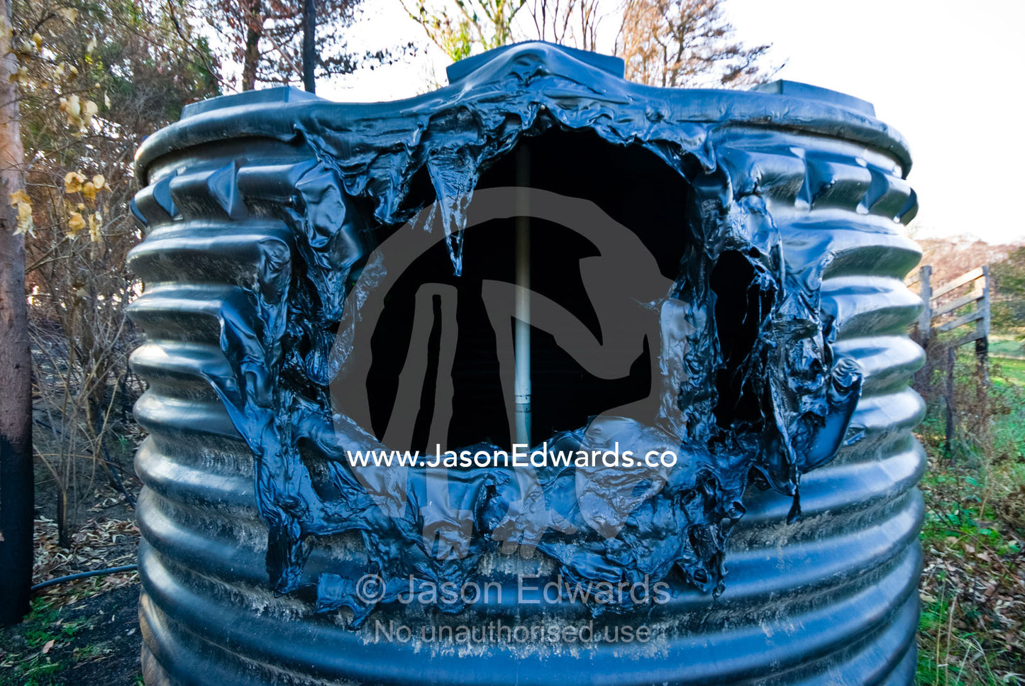 A plastic water tank melted in the extreme heat of a forest fire. Kinglake Central, Victoria, Australia
