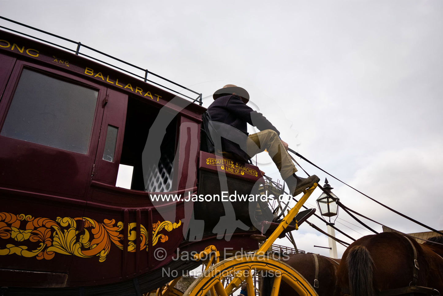 A coachman drives a stagecoach and team of horses. Ballarat, Victoria, Australia.