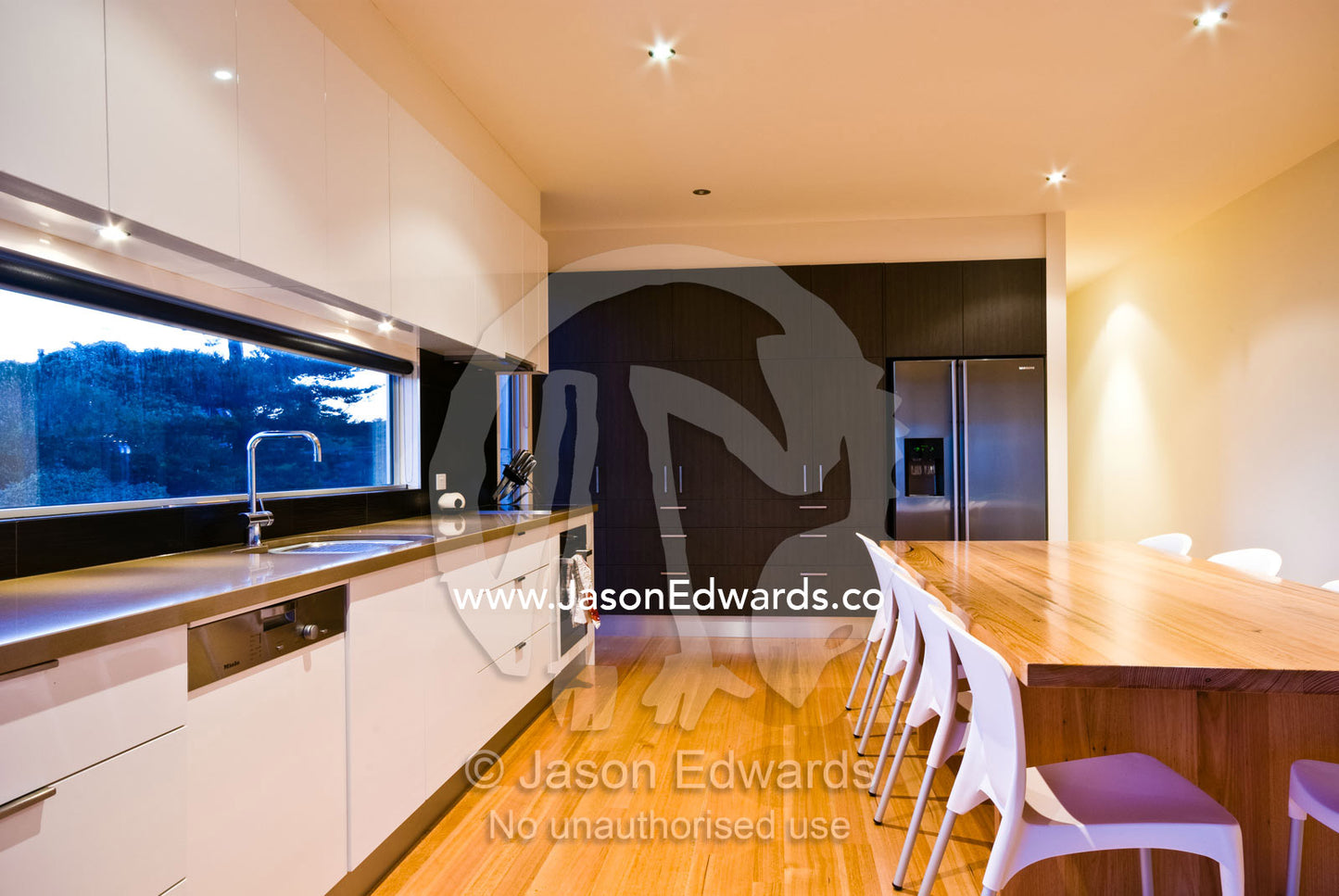 A kitchen and dining table in a modern beach house. Ocean Grove, Victoria, Australia