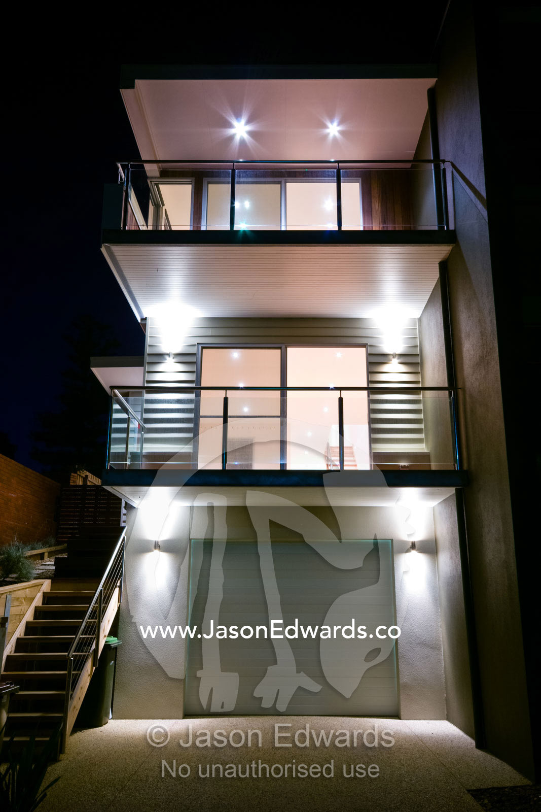 Balconies and a garage in a modern multi-storey beach house at night. Ocean Grove, Victoria, Australia