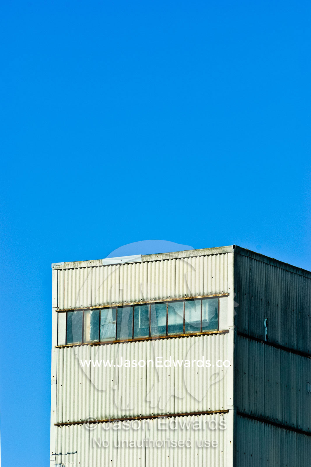 A rectangular rusting corrugated tin factory warehouse facade. Collingwood, Victoria, Australia