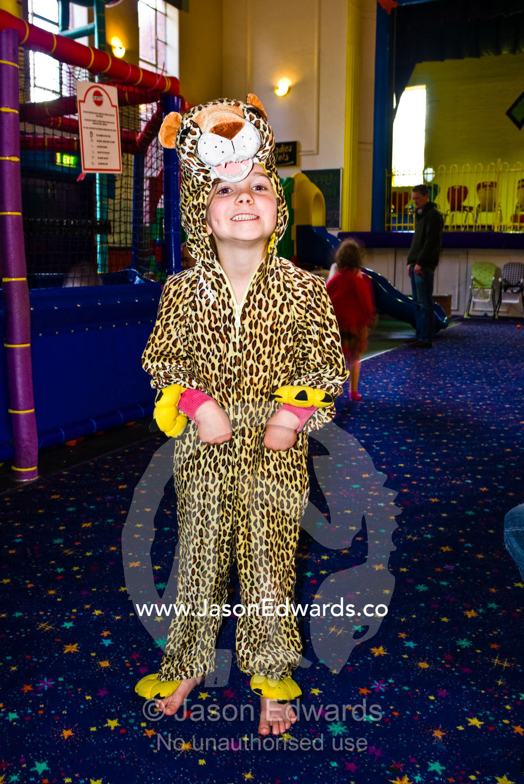 A small girl dresses up as a leopard at a childrens play center. Hawthorn, Victoria, Australia