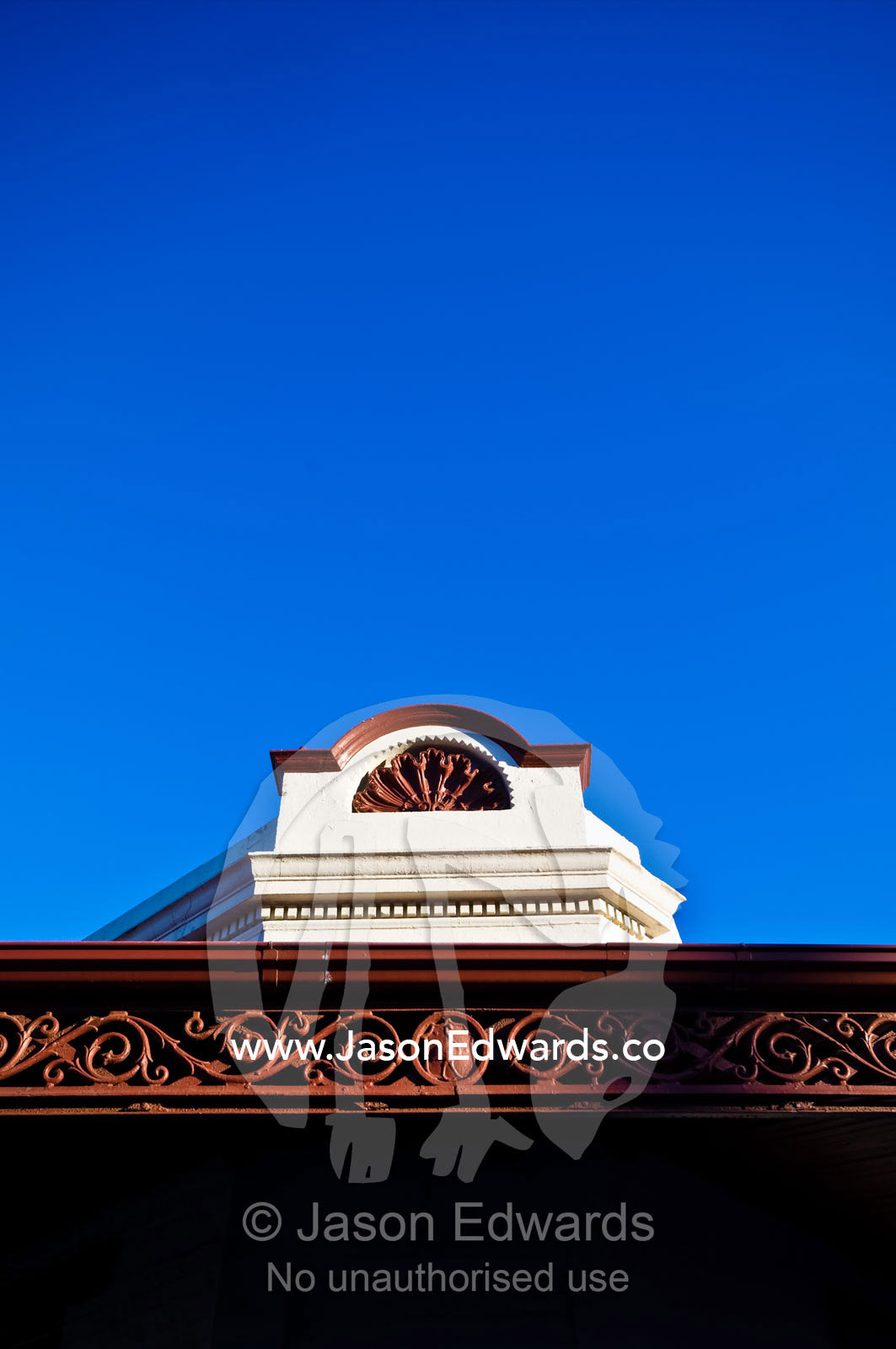 An ornate facade and verandah lattice on an antique terrace house. Carlton North, Victoria, Australia